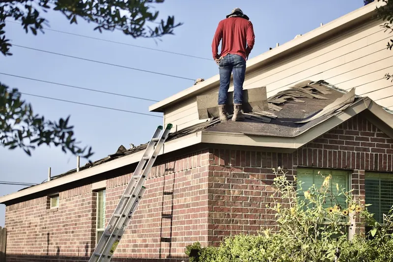 Professional roofer working on a residential roof in North East Harbor